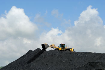 front loader dumping coal over a mountain of coal