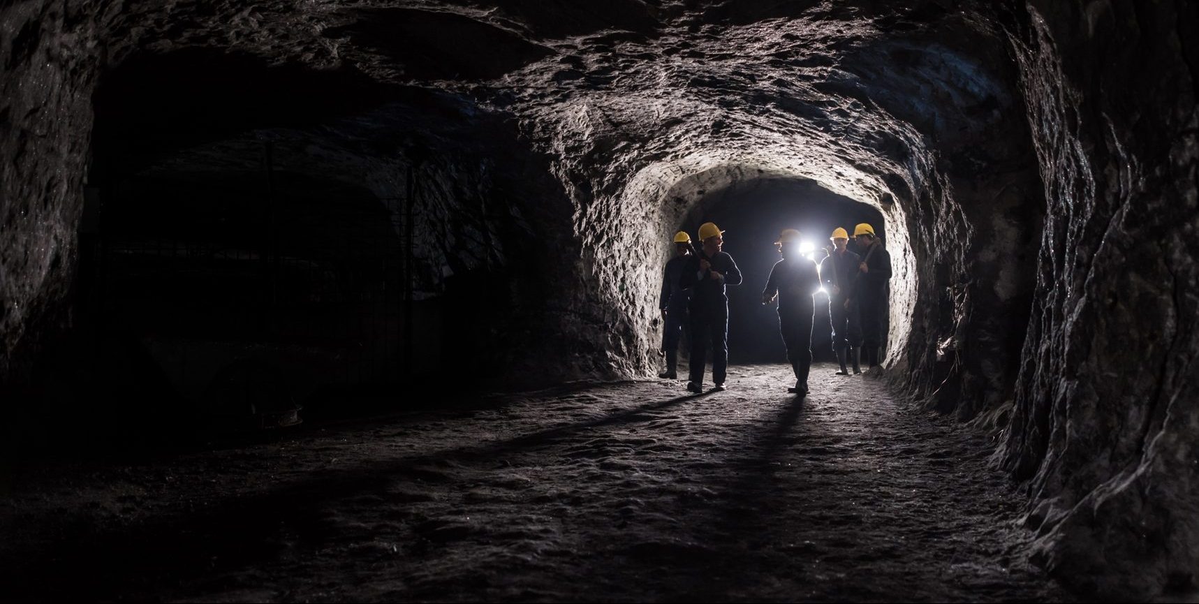 Coal miners talking and walking through a coal mine